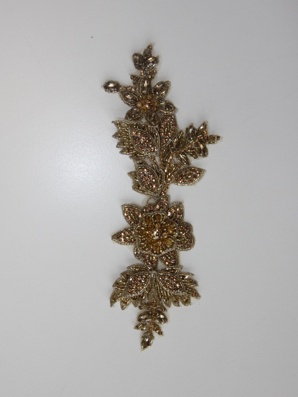 Kristallstickerei (Gold) – Schwerkraft