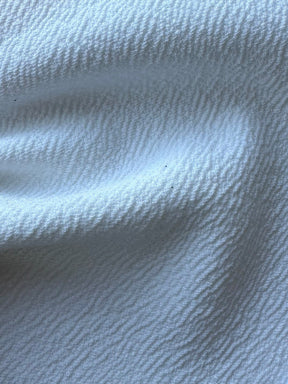 Elfenbeinfarbener, schwerer Polyester-Krepp mit Stretchanteil – Spanien